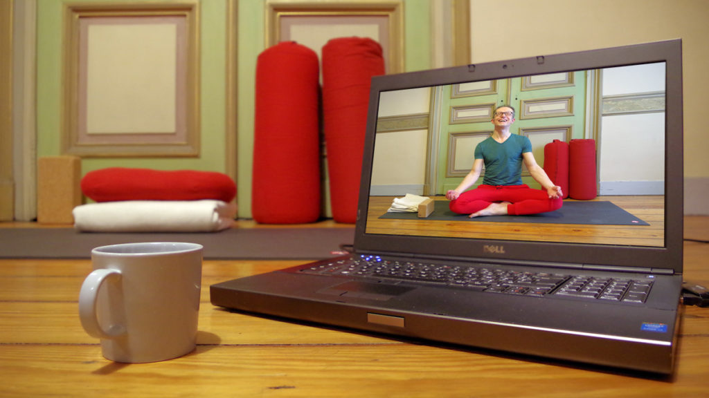 Picture of a live online yoga class on a pc