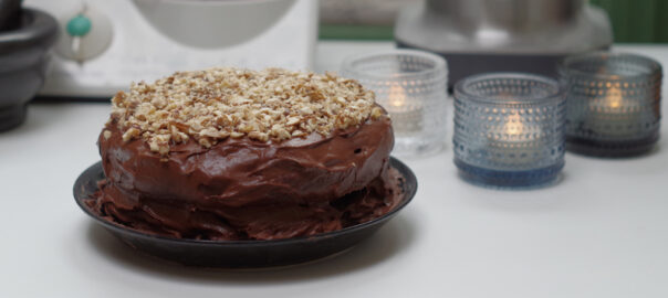 A rich vegan chocolate cake with green leafy vegetables