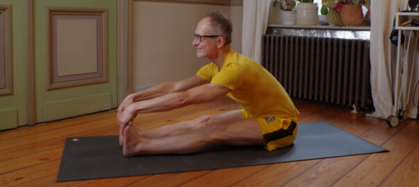 Picture of a man in a seated forward bend